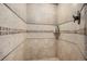 Walk-in shower with decorative tile walls and bronze shower head at 26781 E Clifton Dr, Aurora, CO 80016