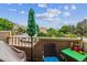 Cozy balcony features a leafy green umbrella, potted plants, and comfortable seating with neighborhood views at 1818 S Quebec Way # 4, Denver, CO 80231