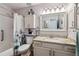 Well-lit bathroom featuring a vanity with granite countertop, a shower with tub, and storage at 1818 S Quebec Way # 4, Denver, CO 80231