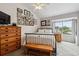 Comfortable bedroom with natural light, a window view, and wood furniture at 1818 S Quebec Way # 4, Denver, CO 80231