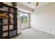 Bright bedroom with a view of the outside through a window and neutral carpeting at 1818 S Quebec Way # 4, Denver, CO 80231