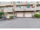 Building 1 showcasing a row of private garages with upper level townhome balconies above at 1818 S Quebec Way # 4, Denver, CO 80231