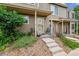Charming front porch with tasteful landscaping and concrete steps leading to the unit at 1818 S Quebec Way # 4, Denver, CO 80231