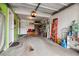 Spacious garage featuring ample storage space, an orange ladder, and an automatic garage door opener at 1818 S Quebec Way # 4, Denver, CO 80231