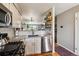 Updated kitchen with granite countertops, stainless steel appliances, and tile backsplash at 1818 S Quebec Way # 4, Denver, CO 80231