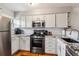 Bright kitchen features stainless steel appliances, granite countertops, and white cabinetry at 1818 S Quebec Way # 4, Denver, CO 80231
