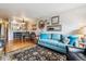 Bright living room with hardwood floors and a glimpse of the modern kitchen and dining space at 1818 S Quebec Way # 4, Denver, CO 80231