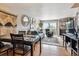 Open-concept living room with fireplace and dining area, filled with natural light at 1818 S Quebec Way # 4, Denver, CO 80231