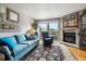Comfortable living room showcasing a fireplace, plush seating, and a sliding glass door to outdoors at 1818 S Quebec Way # 4, Denver, CO 80231