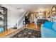 Spacious living room with a staircase, open to the dining area and kitchen, with beautiful flooring at 1818 S Quebec Way # 4, Denver, CO 80231
