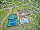 An aerial view of tennis courts and a swimming pool at a beautiful Primary-planned community at 22183 E Rocky Top Pl, Aurora, CO 80016