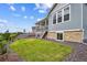 This backyard is landscaped with a grassy area and stone accents at 22183 E Rocky Top Pl, Aurora, CO 80016