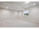 This finished basement offers recessed lighting and a window offering natural light at 22183 E Rocky Top Pl, Aurora, CO 80016