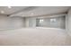 Spacious unfinished basement with natural light and carpet flooring, ready for customization at 22183 E Rocky Top Pl, Aurora, CO 80016