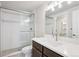 Modern bathroom features glass enclosed shower, chrome fixtures, and a dark wood vanity at 22183 E Rocky Top Pl, Aurora, CO 80016