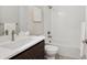 Modern bathroom featuring a shower-tub combo with white tile and stylish fixtures at 22183 E Rocky Top Pl, Aurora, CO 80016