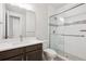 Contemporary bathroom with white countertop vanity and tiled walk-in shower behind glass door at 22183 E Rocky Top Pl, Aurora, CO 80016