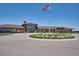 A wide shot of a clubhouse with well-manicured landscaping and an American flag waving at 22183 E Rocky Top Pl, Aurora, CO 80016