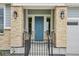 Close up of a stylish front door with stone pillar accents and modern outdoor lighting at 22183 E Rocky Top Pl, Aurora, CO 80016