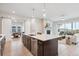 Open kitchen and living area with fireplace, island, and sliding doors to a balcony at 22183 E Rocky Top Pl, Aurora, CO 80016