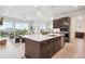 Open concept kitchen with a large island, modern appliances, and access to a spacious living area at 22183 E Rocky Top Pl, Aurora, CO 80016