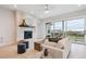 Bright living room featuring a fireplace, large windows, and comfortable seating at 22183 E Rocky Top Pl, Aurora, CO 80016
