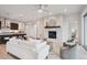 Modern living room with fireplace and an open view to the kitchen, perfect for entertaining at 22183 E Rocky Top Pl, Aurora, CO 80016