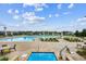 A clear view of a swimming pool with patio seating and lounge chairs on a sunny day at 22183 E Rocky Top Pl, Aurora, CO 80016