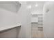 Bright, clean walk-in closet with shelves and hanging rods, providing ample storage space at 22183 E Rocky Top Pl, Aurora, CO 80016