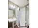 Bathroom with a pedestal sink and walk-in shower at 8371 S Upham Way # 103, Littleton, CO 80128
