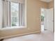 Bright bedroom featuring a large window with curtains and neutral carpet at 8371 S Upham Way # 103, Littleton, CO 80128