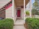 Inviting entryway featuring a red door and well-maintained landscaping at 8371 S Upham Way # 103, Littleton, CO 80128