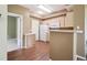 Bright kitchen with light wood cabinetry, white appliances, and a breakfast bar at 8371 S Upham Way # 103, Littleton, CO 80128