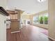 Open-concept living room featuring a fireplace, hardwood floors, and seamless access to the kitchen at 8371 S Upham Way # 103, Littleton, CO 80128