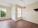 Bright living room with vaulted ceilings, wood-look floors, and large windows providing ample natural light at 8371 S Upham Way # 103, Littleton, CO 80128