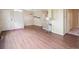 Spacious living room with hardwood floors leading to the entrance and adjacent rooms at 8371 S Upham Way # 103, Littleton, CO 80128