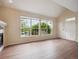 Bright living room with large windows, vaulted ceilings, and hardwood floors offers ample space at 8371 S Upham Way # 103, Littleton, CO 80128