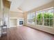 Sunlit living room features a fireplace, vaulted ceilings, and large windows showcasing outdoor views at 8371 S Upham Way # 103, Littleton, CO 80128