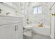 Updated bathroom with marble tile and gold fixtures at 720 Raleigh St, Denver, CO 80204