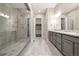 Luxurious bathroom with a glass shower, double vanity, and tile flooring at 6725 Mentha Dr, Castle Rock, CO 80108