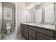 Well-lit bathroom with a granite countertop vanity, gray cabinets, and a walk-in shower at 6725 Mentha Dr, Castle Rock, CO 80108