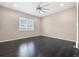 Bright bedroom with hardwood floors and a large window with plantation shutters at 6725 Mentha Dr, Castle Rock, CO 80108