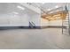 Spacious garage with high ceilings and a custom-built loft area with access ladder for extra storage at 6725 Mentha Dr, Castle Rock, CO 80108