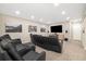 Finished basement home theater with tiered seating and a large flat screen TV at 6725 Mentha Dr, Castle Rock, CO 80108