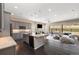 Modern kitchen featuring granite countertops, stainless steel appliances, and a large island at 6725 Mentha Dr, Castle Rock, CO 80108