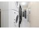 Efficient laundry room features stacked appliances and built-in shelving for organized storage at 6725 Mentha Dr, Castle Rock, CO 80108