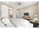 Relaxing main bedroom with elegant furniture, a modern ceiling fan, and an ensuite bathroom at 6725 Mentha Dr, Castle Rock, CO 80108