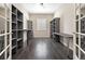 Large office space with hardwood floors, custom built-in shelving, and natural light at 6725 Mentha Dr, Castle Rock, CO 80108
