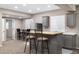 Finished basement wet bar with wooden countertops, sink, cabinets, and bar stool seating at 6725 Mentha Dr, Castle Rock, CO 80108