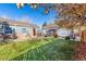 Home exterior featuring a well-maintained lawn, stone accents, and a charming pathway leading to the front door at 1050 S Raleigh St, Denver, CO 80219